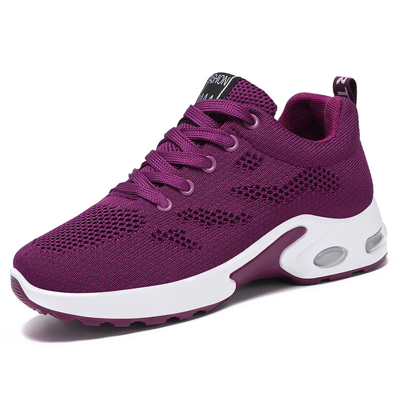 Purple sneaker with white sole on a white background