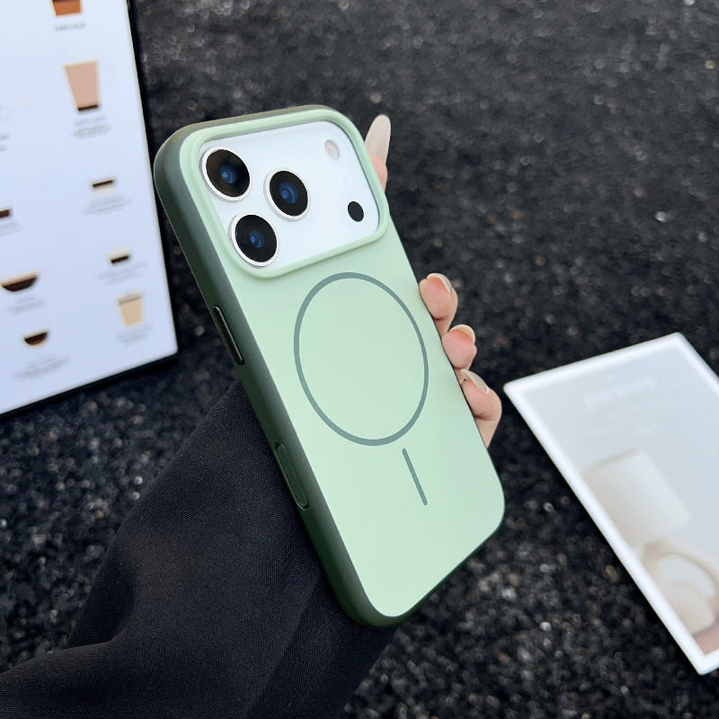 Mint green phone case with circular button detail, shown in hand