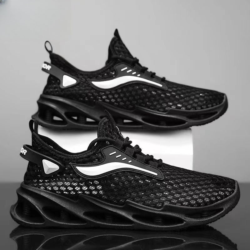 Black athletic shoes with white accents on a reflective surface and gray background