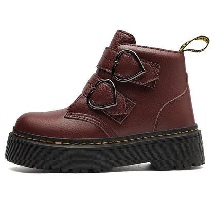 Brown leather boot with heart-shaped buckles on a white background