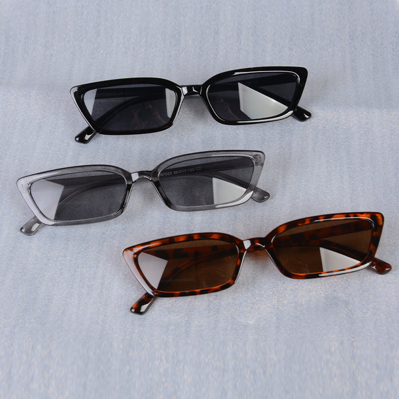 Three pairs of sunglasses with different frame colors on a light gray background