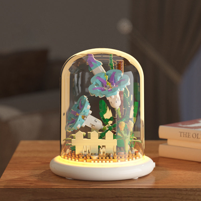 Decorative lamp with colorful butterfly figurines inside a glass dome on a wooden surface.
