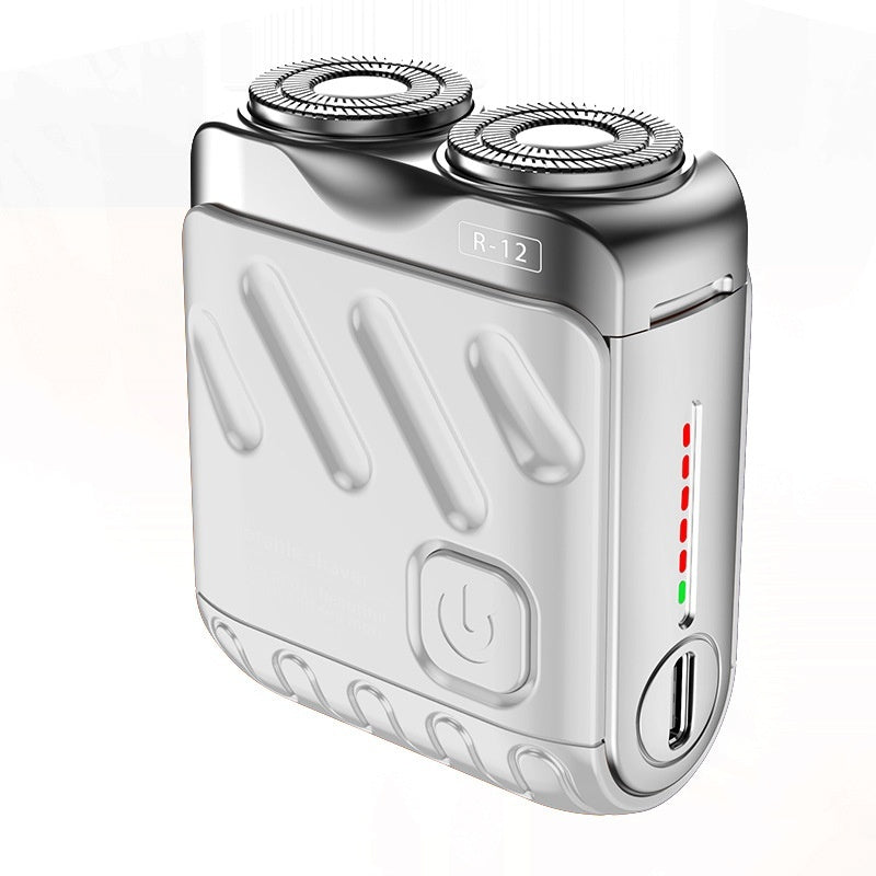 Silver electric shaver with charging indicator on a white background