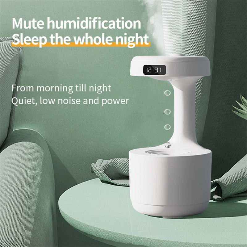 White humidifier on a table with text about its features, placed against a green wall.