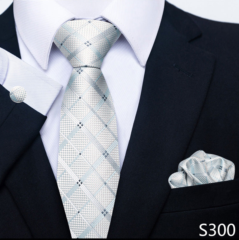 Black suit with a patterned tie and pocket square, brand 'S300' visible.
