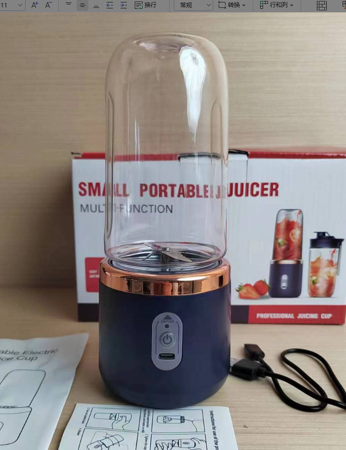 Small portable juicer with packaging and accessories on a table