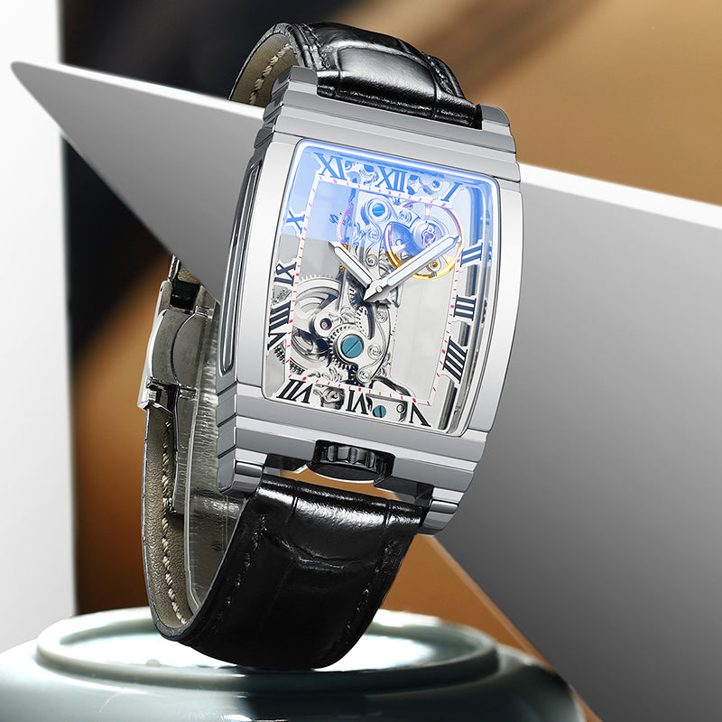 Silver skeleton mechanical watch with black leather strap and blue openwork dial