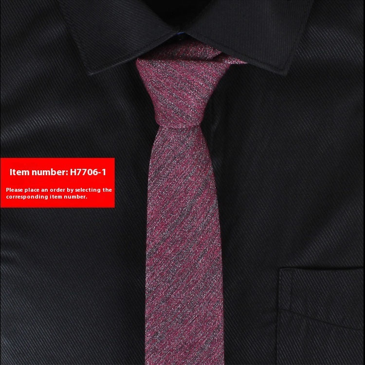 Black shirt with a purple tie and a red label with item number H7706-1.