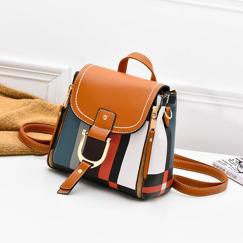 Orange and plaid crossbody bag with flap buckle and front zip closure