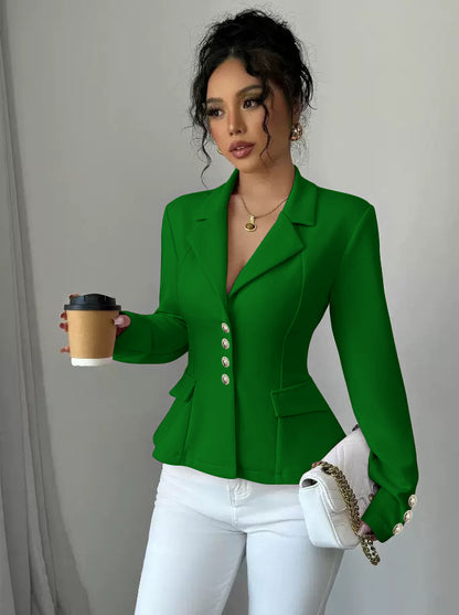 Woman in a green blazer holding a coffee cup against a plain background