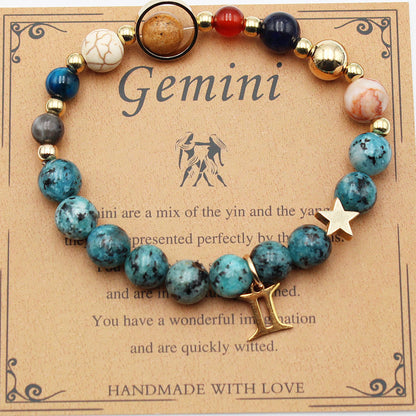 Zodiac bracelet with blue stone beads, gold-tone accents, and star and Gemini charm