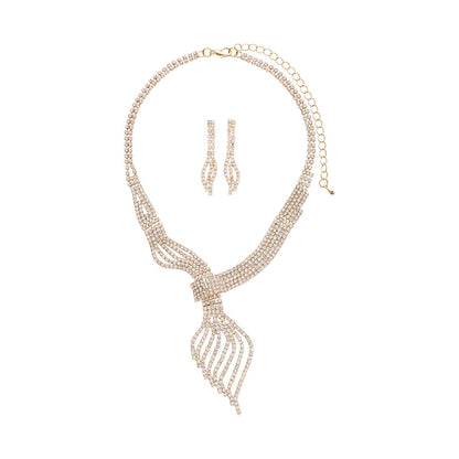 Rose gold necklace and earrings set on a white background