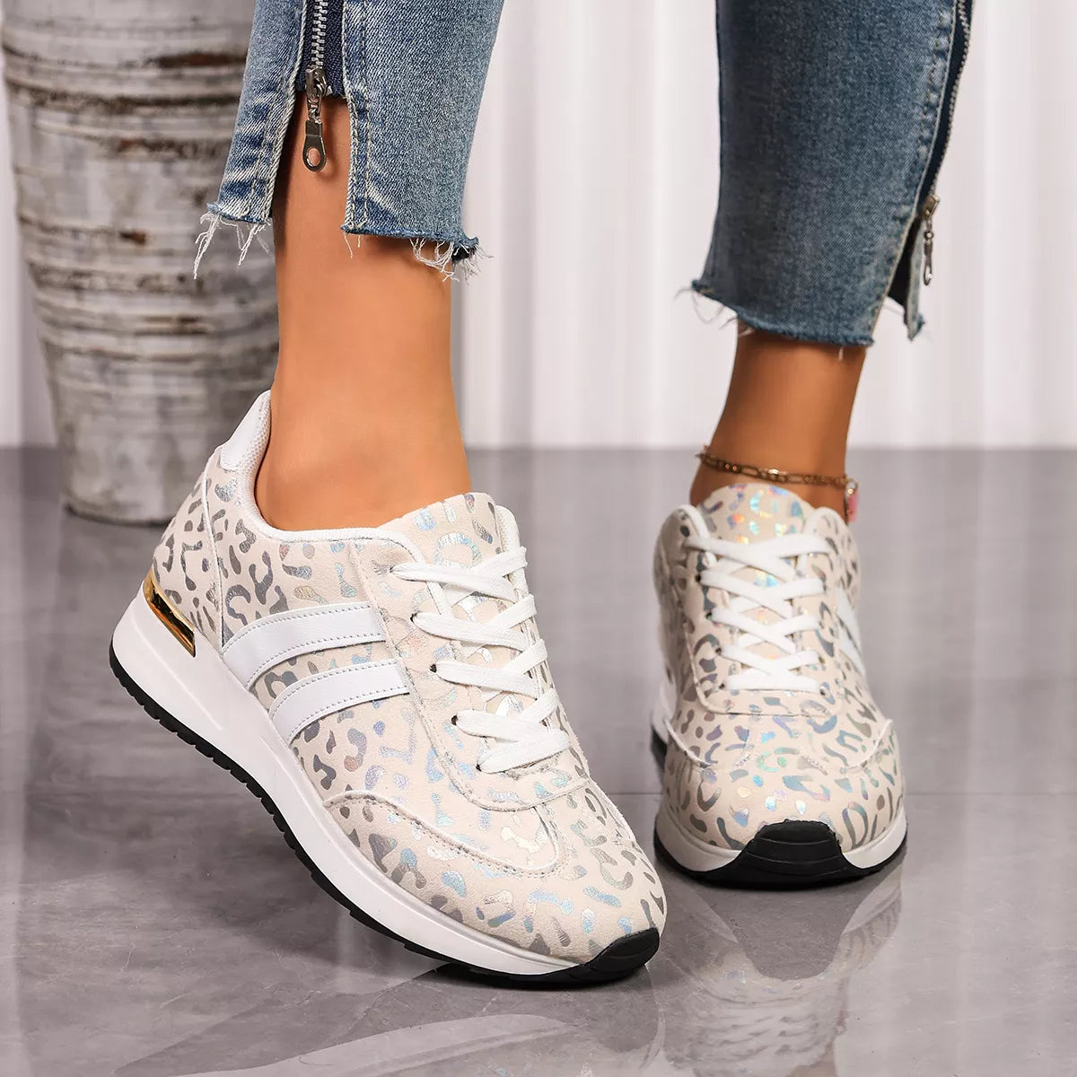 Leopard print lace-up sneakers with white laces, side straps, and black tread sole