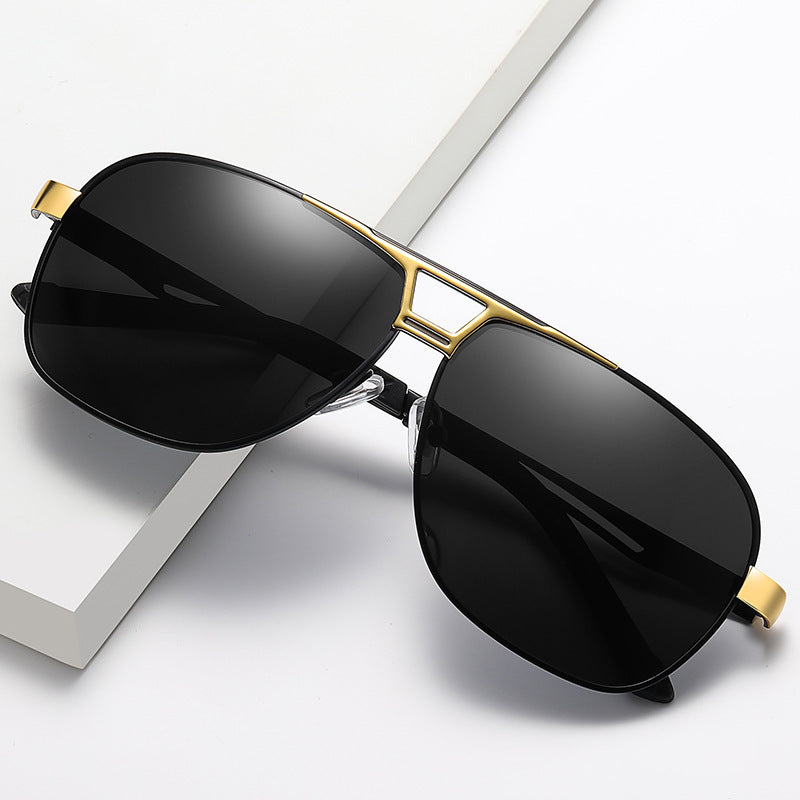 Black sunglasses with gold frames on a white background