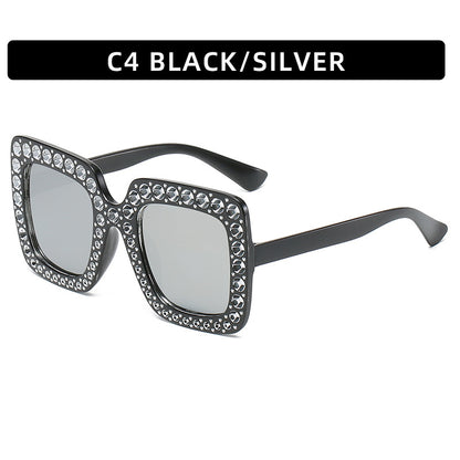 Black and silver sunglasses with gemstones on a white background