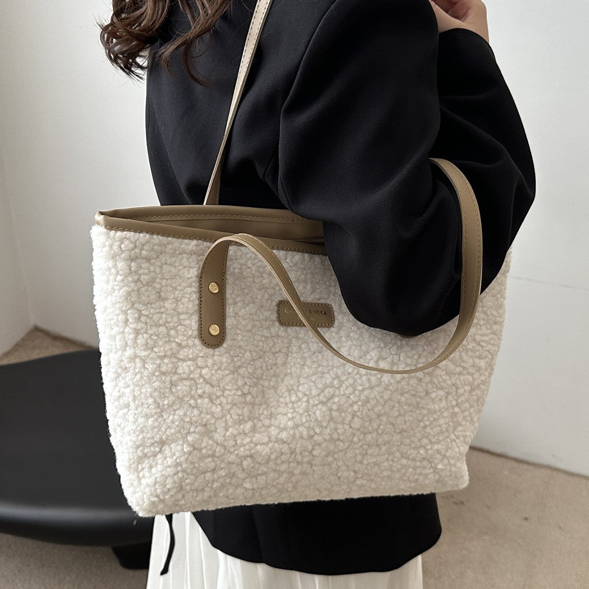 Beige furry tote shoulder bag with dual handles and small front logo patch