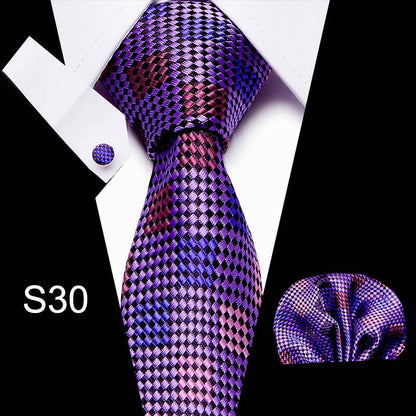 Purple and pink checkered tie set with pocket square and cufflinks on a white background