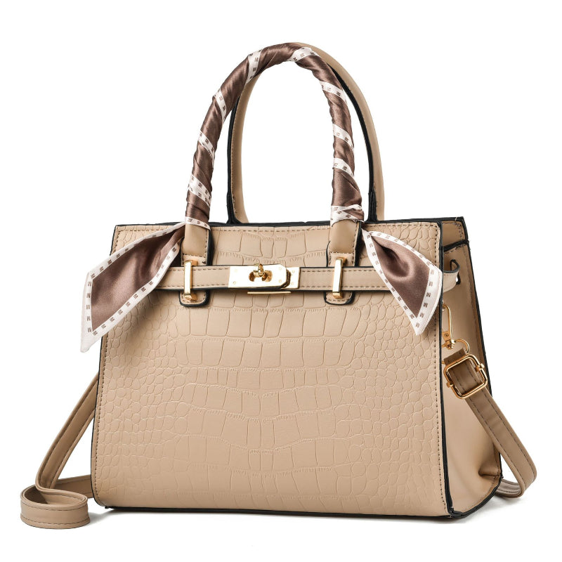 Beige handbag with a decorative ribbon on a white background