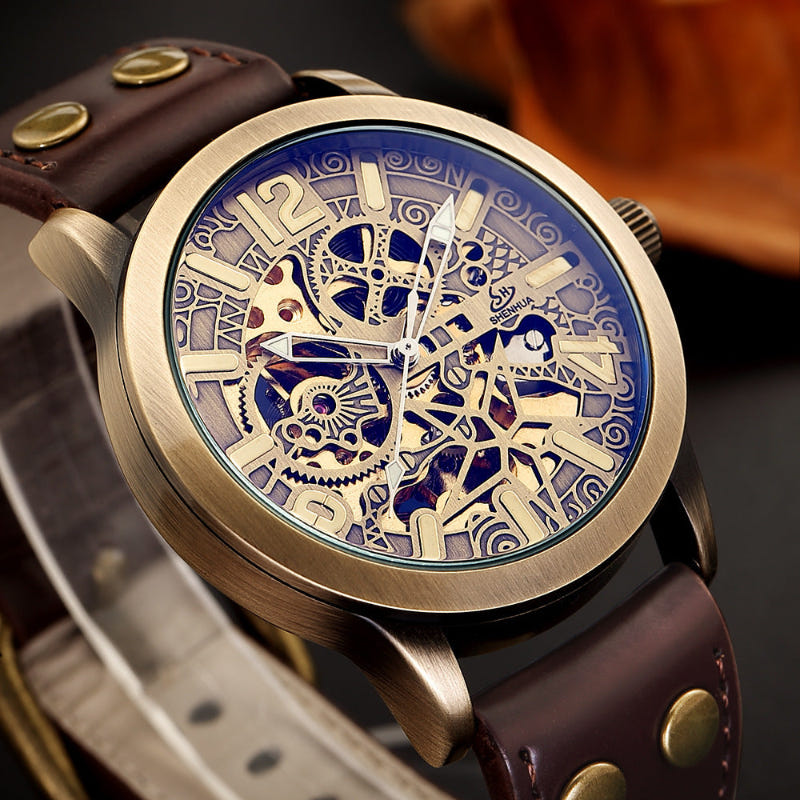 Mechanical watch with brown leather strap and decorative skeleton dial