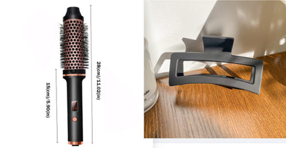 Black electric hair curler brush with vented barrel and control buttons; side view