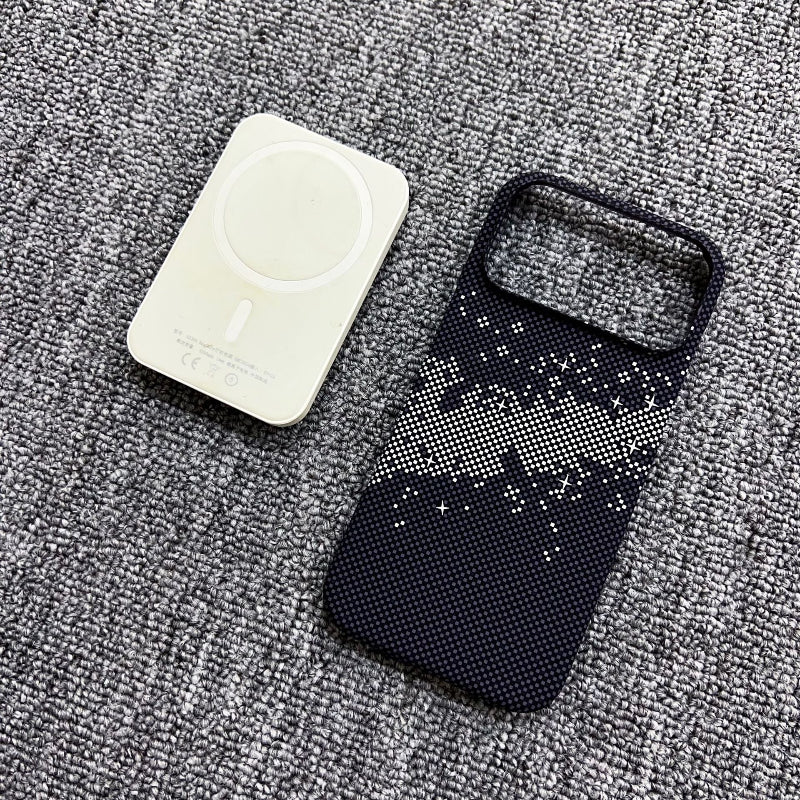 Black glittery phone case and white charging cable on a gray textured surface