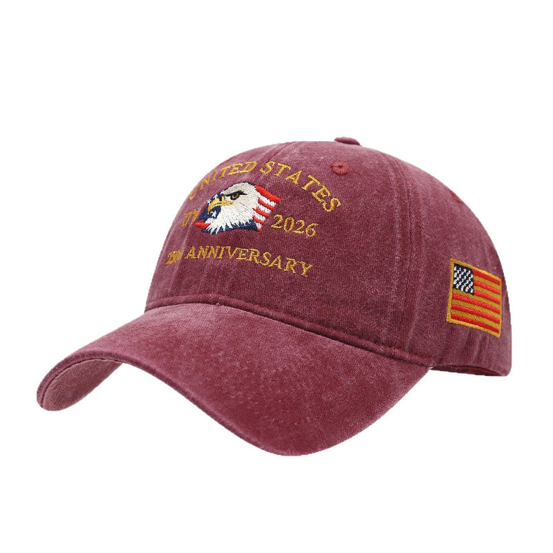 Burgundy washed-print cap with gold “United States 1776–2026” eagle graphic and flag patch.