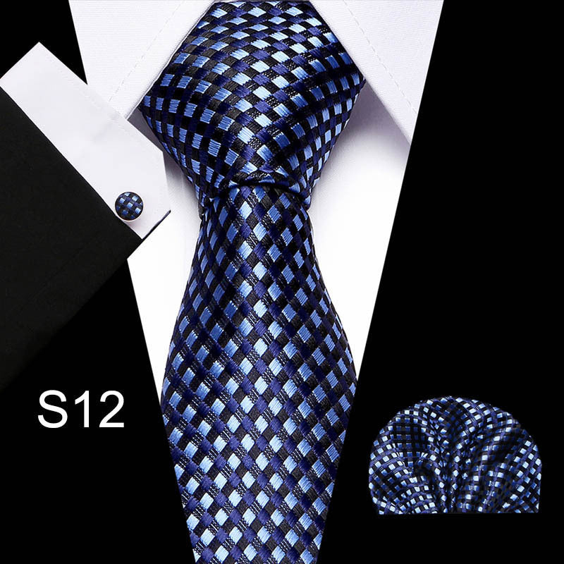 Blue checkered tie with matching pocket square and cufflinks on a white background