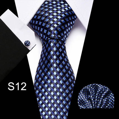 Blue checkered tie with matching pocket square and cufflinks on a white background