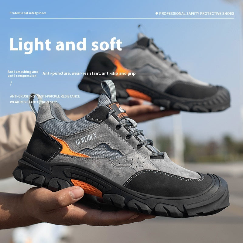 Gray and black safety shoes with orange accents held by a person, against a blurred outdoor background.