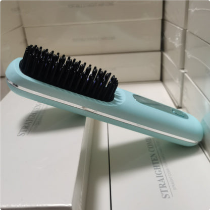 Blue hairbrush with black bristles on a white surface
