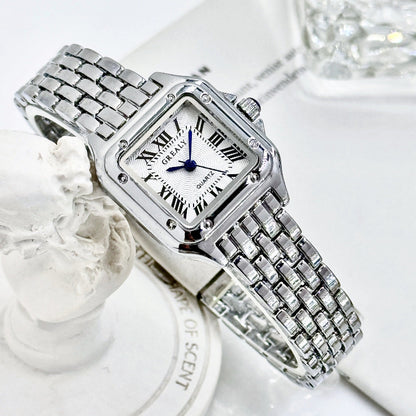 Silver wristwatch with a white face on a white background