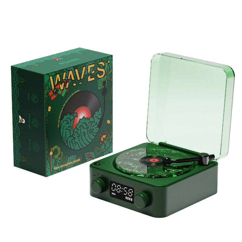 Green record player with open lid and decorative box on a white background