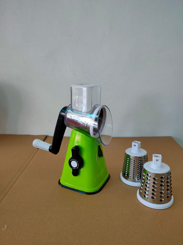 Green vegetable cutter slicer with clear hopper and rotary grater attachments