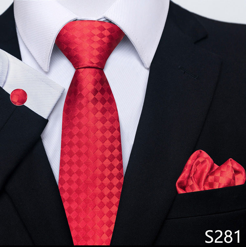 Red patterned tie and matching pocket square with a black suit and white shirt.