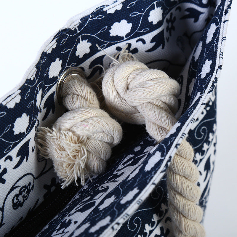 Navy and white patterned bag with cream-colored yarn inside