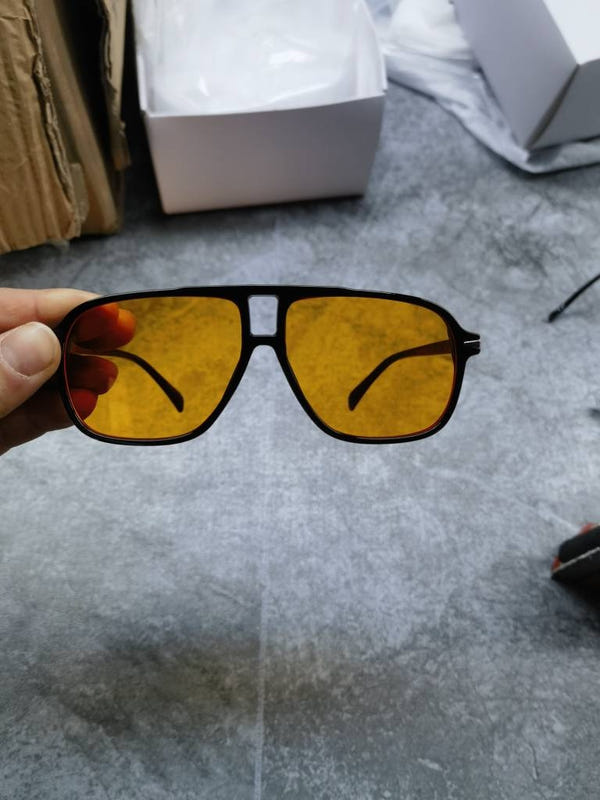 Amber/yellow lens sunglasses with black frame and angular shape
