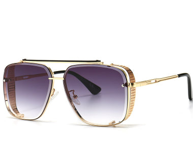 Gold-framed sunglasses with gradient lenses on a white background