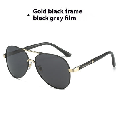 Sunglasses with gold frame and black gray lenses on a white background