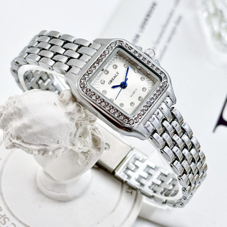 Silver watch with diamond accents on a white background
