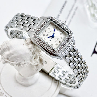 Silver watch with diamond accents on a white background
