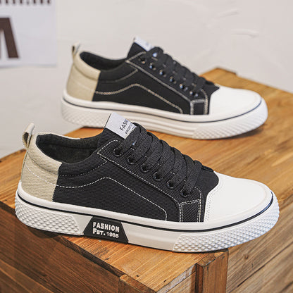 Black and white sneakers with beige accents on a wooden surface