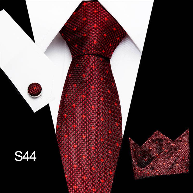 Red patterned tie with matching pocket square on a black and white background