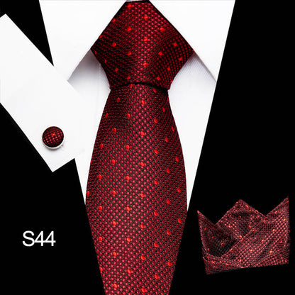 Red patterned tie with matching pocket square on a black and white background