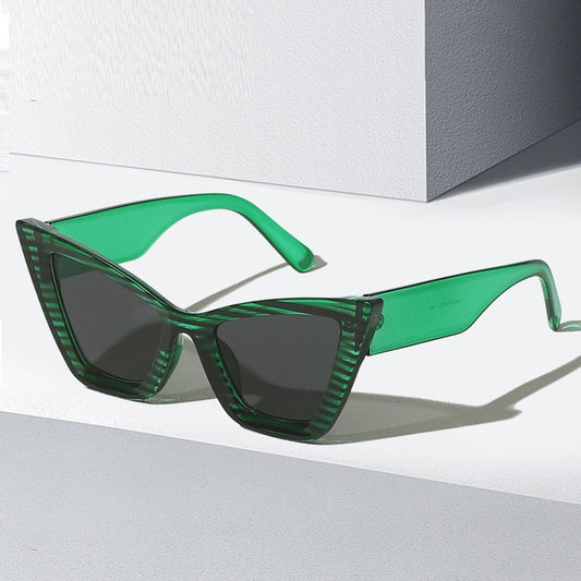Green sunglasses with a geometric frame on a white background