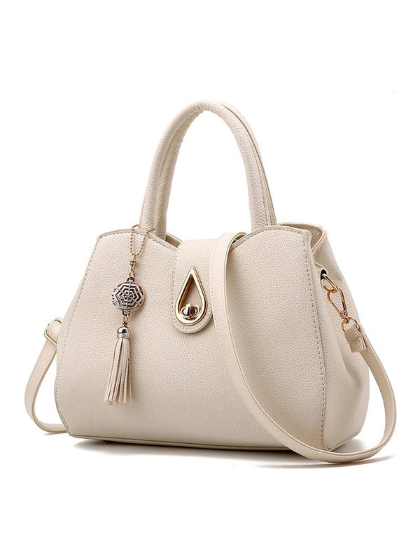 Women’s PU leather handbag, cream, top handles and crossbody strap, front tassel charm