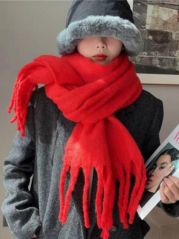Person wearing a red scarf and gray hat indoors