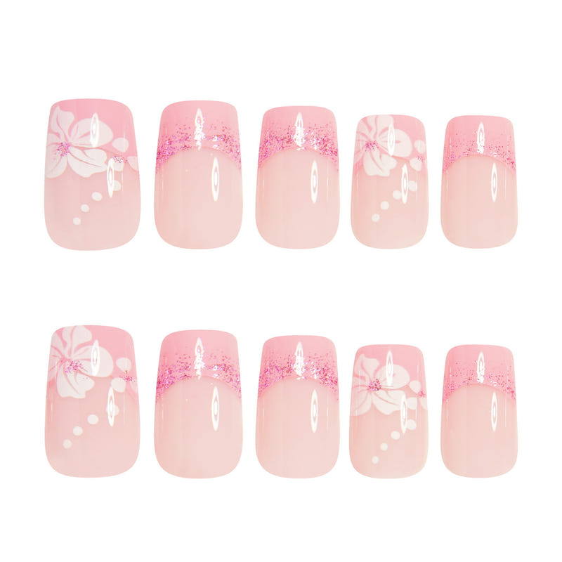 Assorted pink press-on nails with French tips, white bow details, and sparkly glitter tops