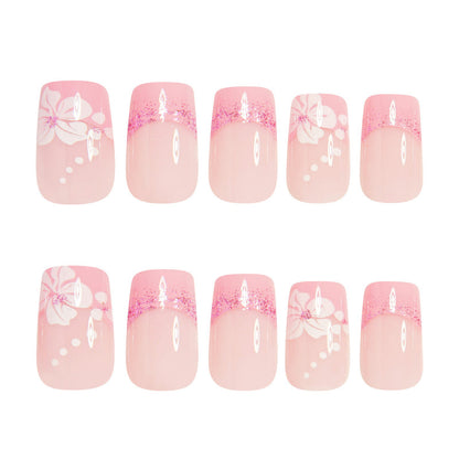 Assorted pink press-on nails with French tips, white bow details, and sparkly glitter tops