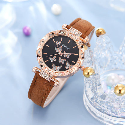Watch with butterfly design on a light blue background