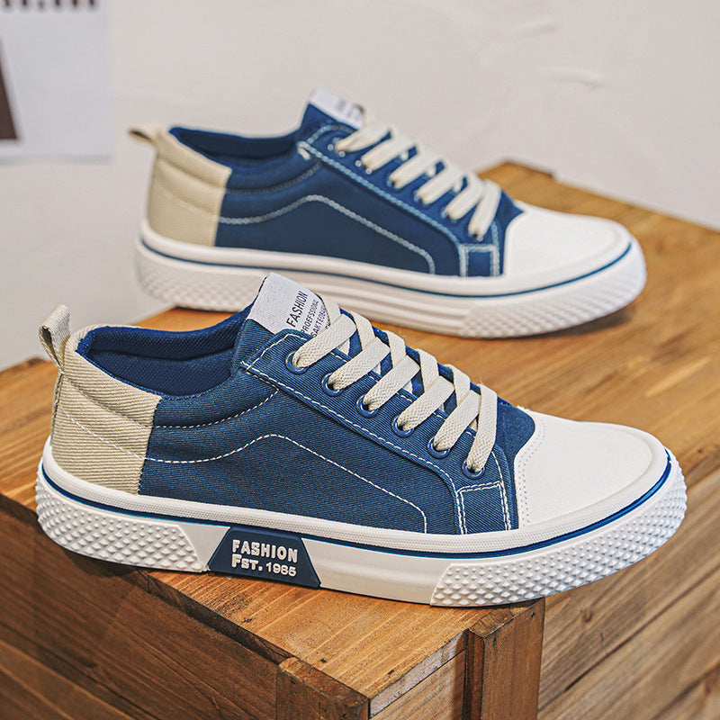 Blue and white sneakers on a wooden surface with a blurred background